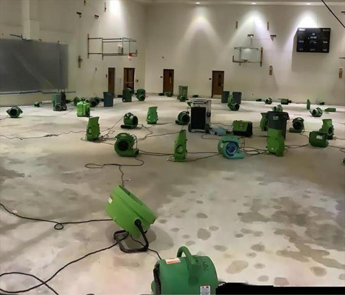 "air movers and dehumidifiers in a church gym"