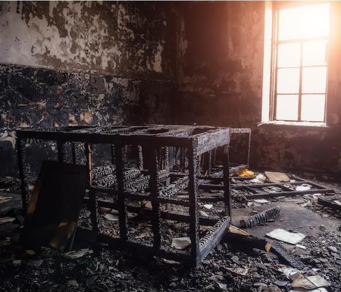 = "interior view of a room with items completely destroyed by fire  " 