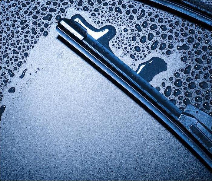 img src =”window.jpg” alt = "a close-up image of a wiper blade wiping away condensation on a car windshield” >