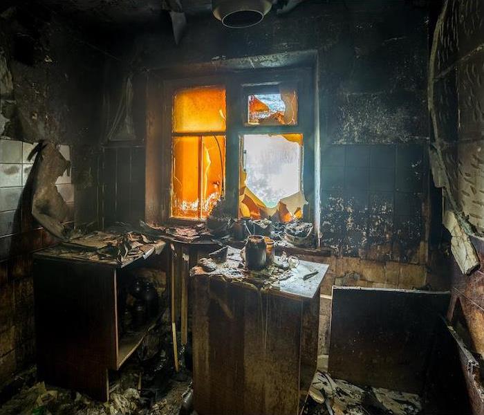 < img src =”fire.jpg” alt = “a small interior room showing extensive damage from a recent fire" >